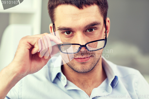 Image of portrait of businessman in eyeglasses at office