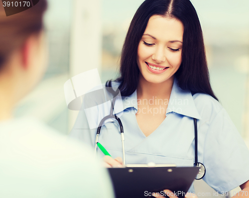 Image of smiling doctor or nurse with patient