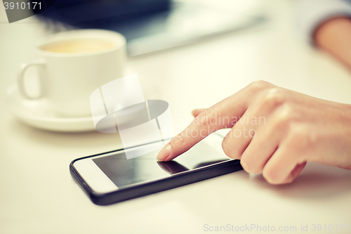 Image of close up of woman hand with smartphone and coffee