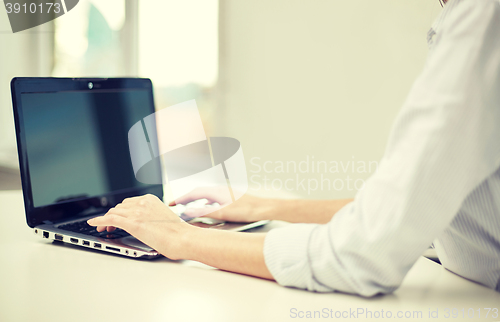 Image of close up of woman typing on laptop at office