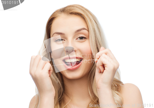 Image of happy young woman with dental floss cleaning teeth