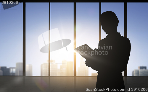 Image of silhouette of business woman with tablet pc