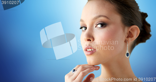 Image of beautiful woman with earring and finger ring