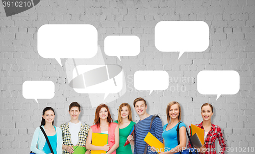 Image of group of teenage students with folders and bags