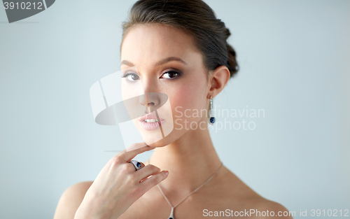 Image of beautiful woman with earring, ring and pendant