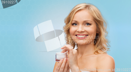 Image of happy woman with cream jar