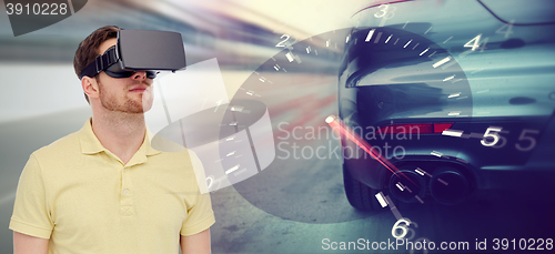 Image of man in virtual reality headset and car racing game