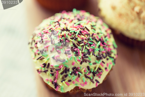 Image of close up of glazed cupcake or muffin on table