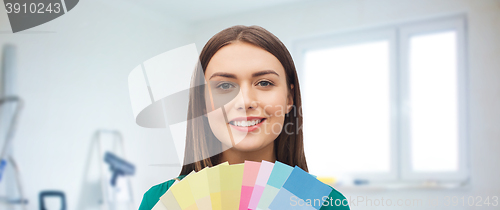 Image of smiling young woman with color swatches