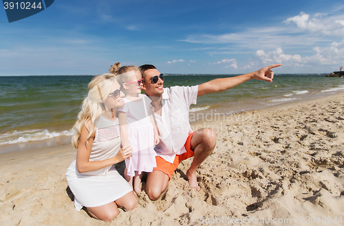 Image of happy family in sunglasses on summer beach