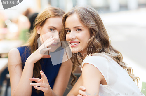 Image of young women drinking coffee and talking at cafe