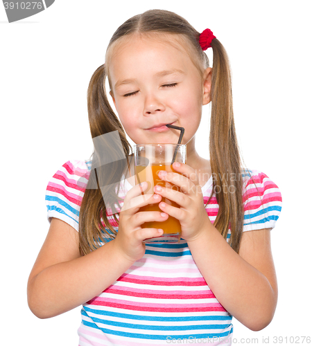 Image of Little girl is drinking carrot juice