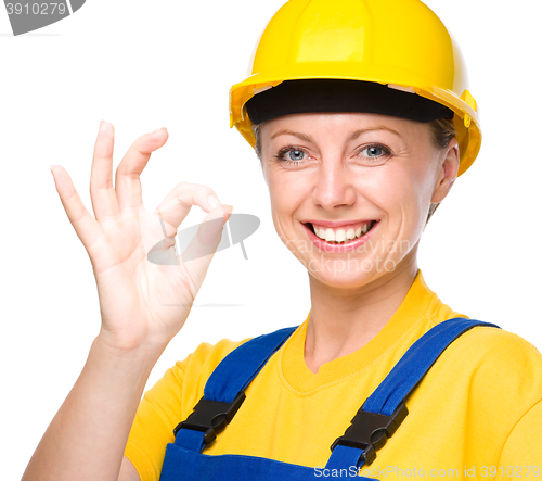 Image of Young construction worker is showing OK sign