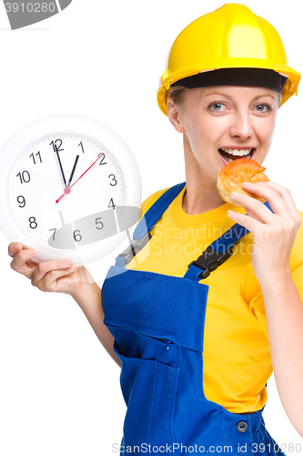 Image of Young construction worker is going to lunch