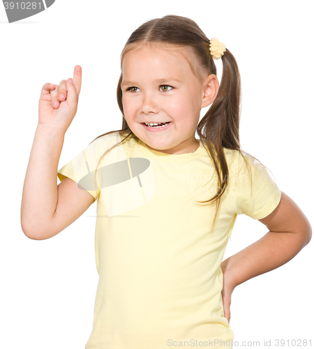 Image of Cute little girl is pointing up