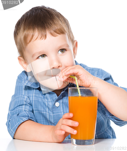 Image of Little boy with glass of carrot juice