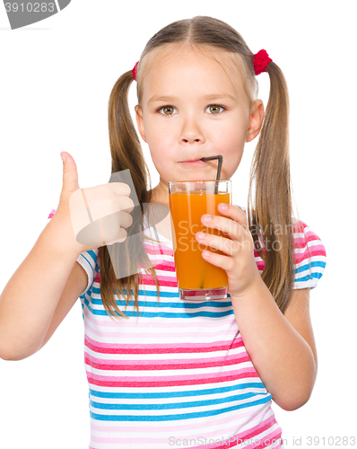 Image of Little girl is drinking carrot juice