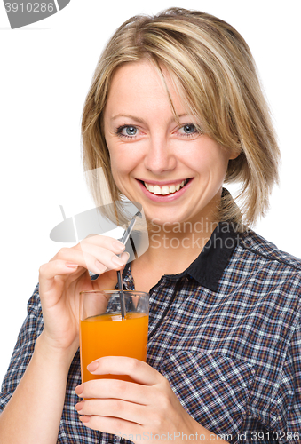 Image of Young woman is drinking carrot juice