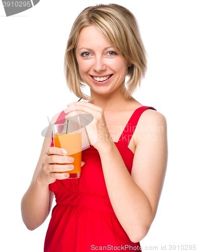 Image of Young woman is drinking carrot juice