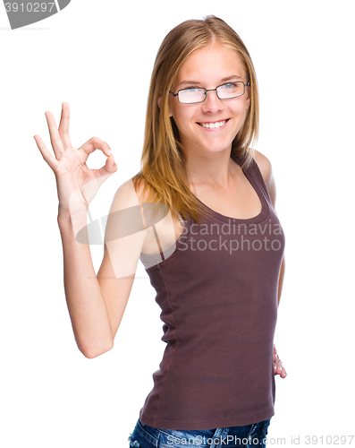 Image of Young teen girl is showing OK sign