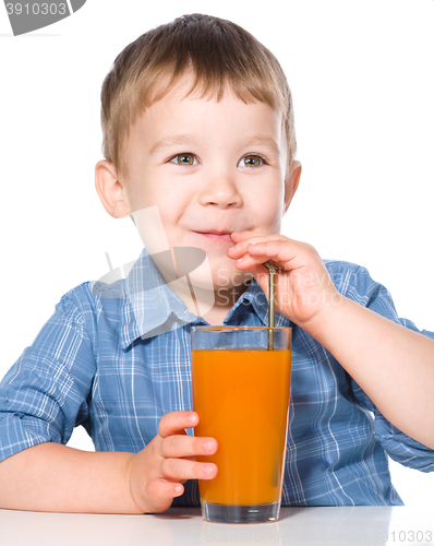 Image of Little boy with glass of carrot juice