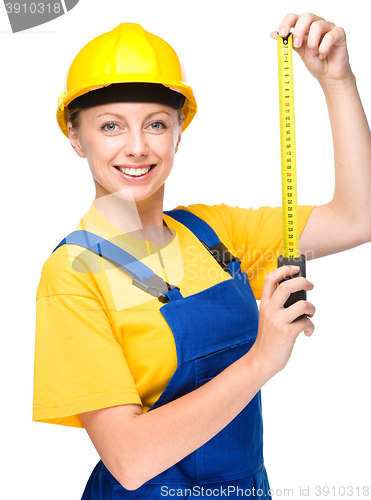 Image of Young construction worker with tape measure