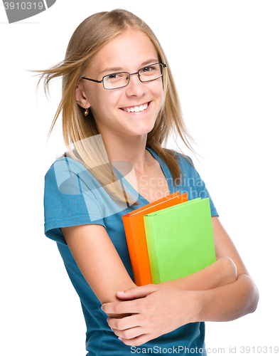 Image of Young student girl is holding book