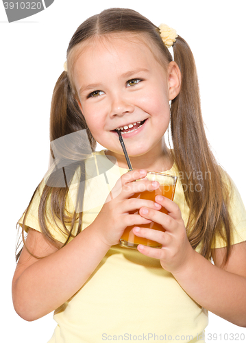 Image of Little girl is drinking carrot juice