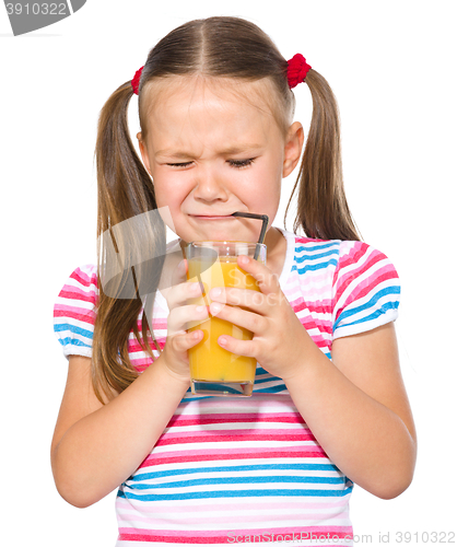 Image of Little girl unwillingly drinking orange juice