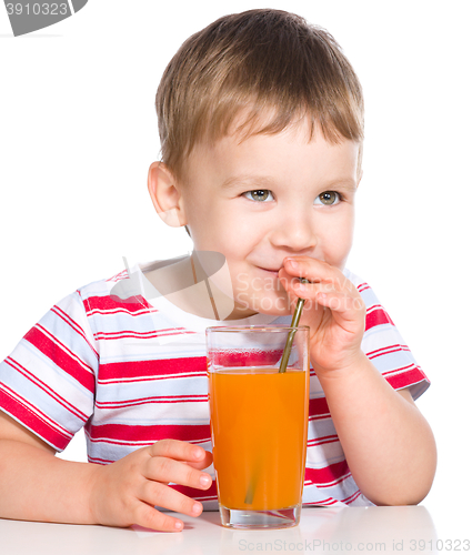 Image of Little boy with glass of carrot juice