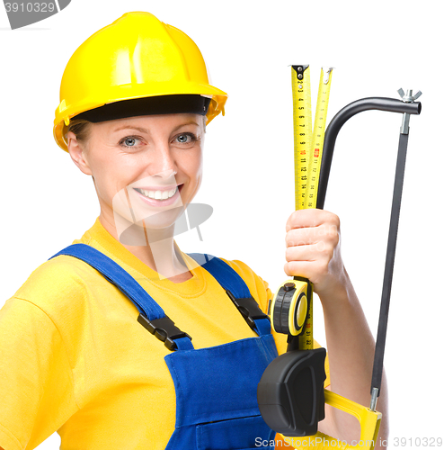 Image of Young construction worker with hacksaw