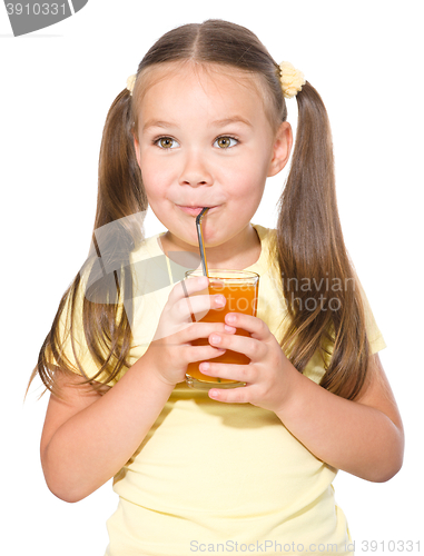 Image of Little girl is drinking carrot juice