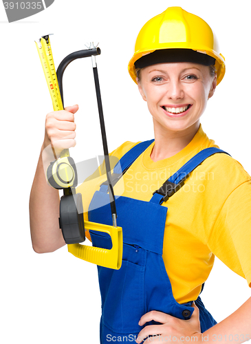 Image of Young construction worker with hacksaw