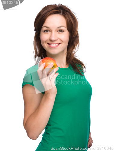 Image of Young happy girl with apple