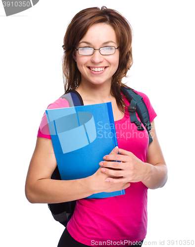 Image of Young student girl is holding book