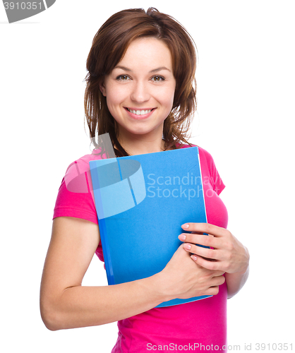 Image of Young student girl is holding exercise book