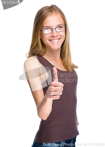 Image of Young teen girl is showing thumb up gesture