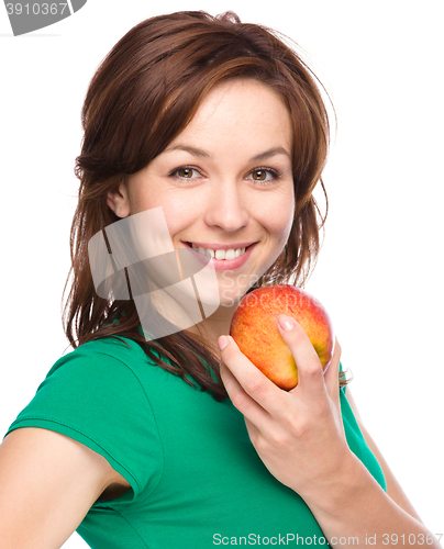 Image of Young happy girl with apple