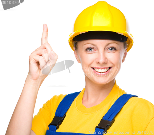 Image of Young construction worker pointing up