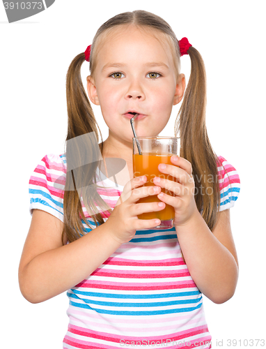 Image of Little girl is drinking carrot juice