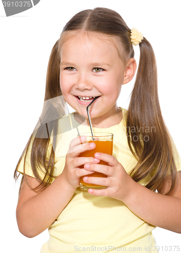 Image of Little girl is drinking carrot juice