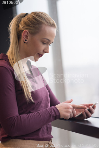 Image of business woman using smart phone at office