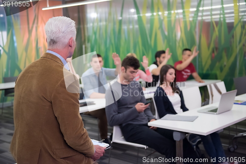 Image of teacher with a group of students in classroom