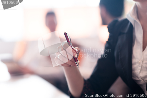 Image of woman hands holding pen on business meeting