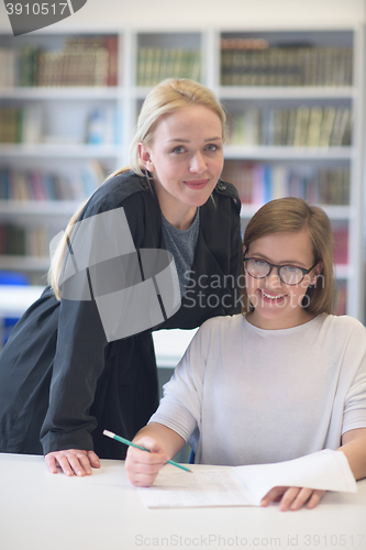 Image of female teacher helping students on class