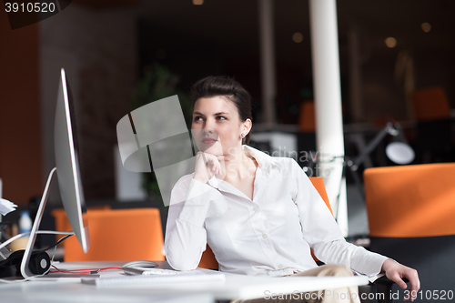 Image of happy young business woman relaxing and geting insiration