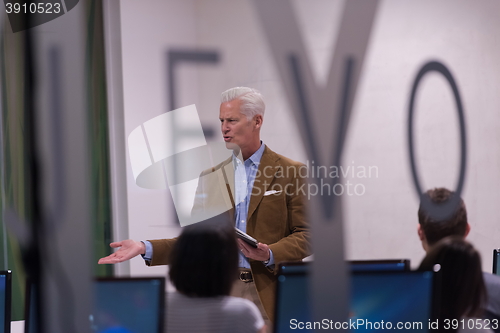 Image of teacher and students in computer lab classroom