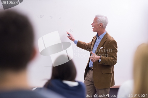 Image of teacher with a group of students in classroom
