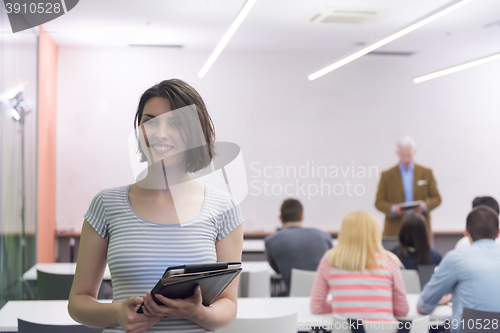 Image of portrait of happy female student in classroom