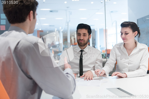 Image of young couple signing contract documents on partners back